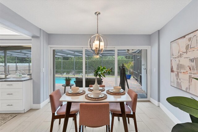 dining area featuring a notable chandelier, light hardwood / wood-style flooring, and a healthy amount of sunlight