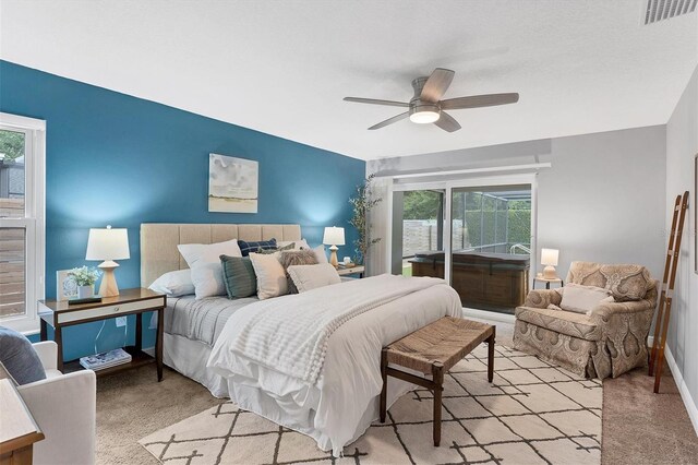 bedroom featuring multiple windows, ceiling fan, and light colored carpet