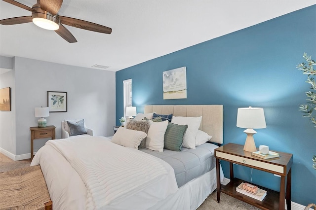 carpeted bedroom featuring a ceiling fan and baseboards