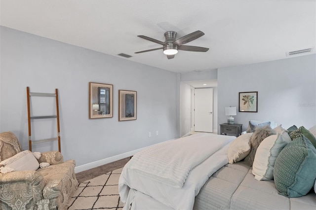 bedroom featuring ceiling fan, light colored carpet, visible vents, and baseboards