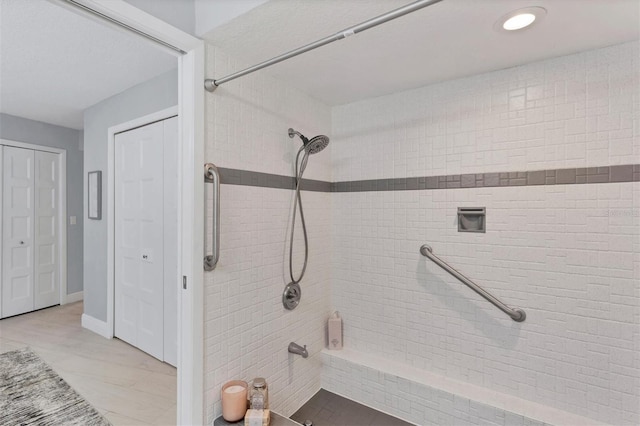 full bath with a tile shower