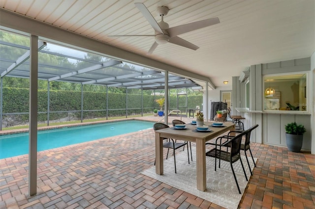 view of pool featuring ceiling fan, a patio area, and a lanai