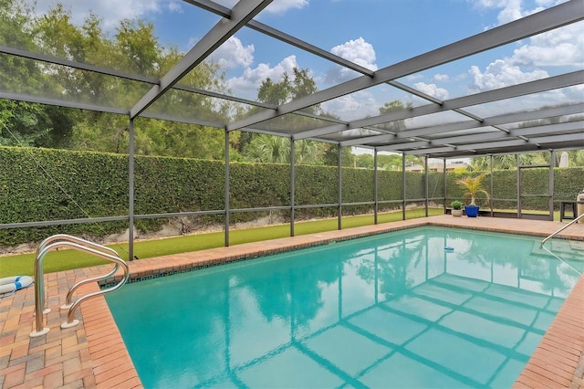 view of swimming pool featuring a patio area and a lanai