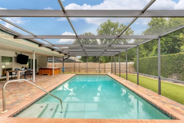 view of swimming pool featuring a patio and glass enclosure