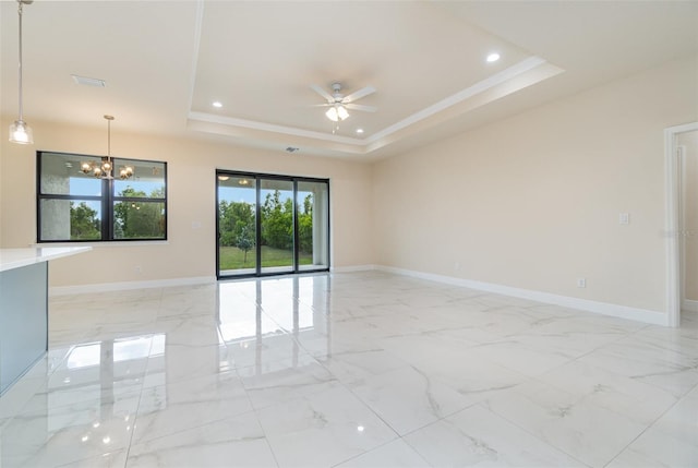 spare room with ceiling fan with notable chandelier, ornamental molding, and a raised ceiling