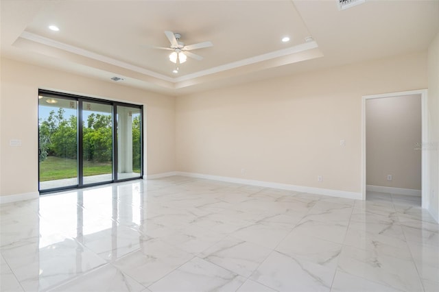 empty room with ceiling fan, ornamental molding, and a raised ceiling