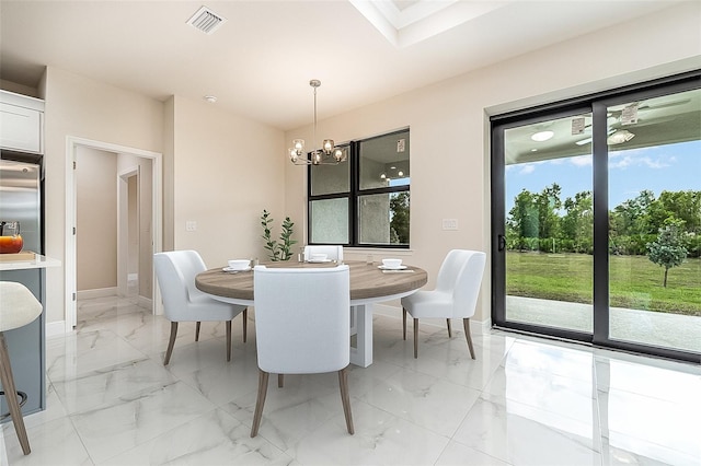 dining area featuring marble finish floor, plenty of natural light, visible vents, and baseboards