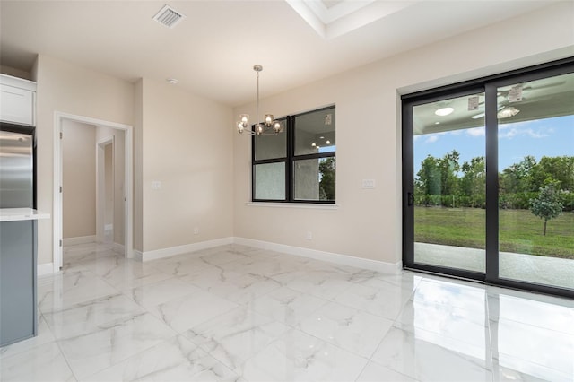 spare room with marble finish floor, visible vents, and baseboards