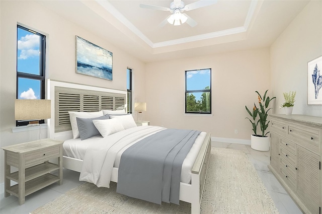 bedroom featuring a raised ceiling, ceiling fan, marble finish floor, and baseboards