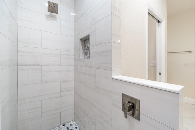 bathroom with a tile shower