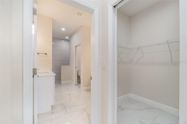 interior space featuring marble finish floor, visible vents, and baseboards