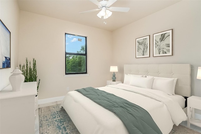 bedroom with ceiling fan and baseboards