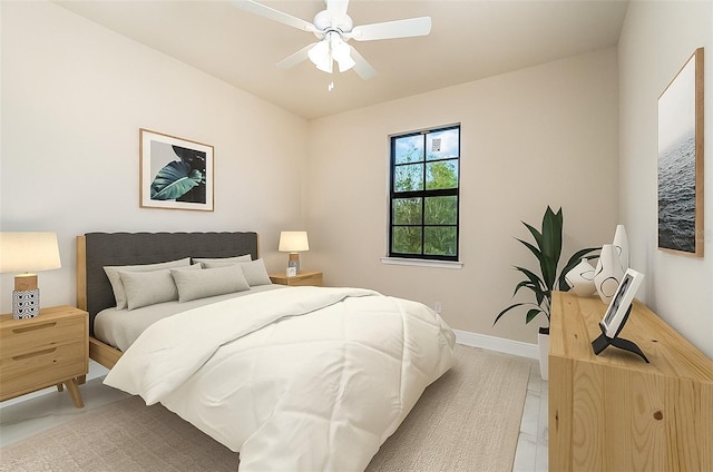 bedroom with a ceiling fan and baseboards