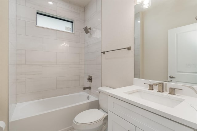 full bathroom featuring tiled shower / bath combo, vanity, and toilet