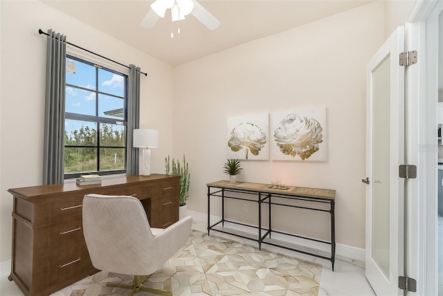 office featuring ceiling fan and baseboards