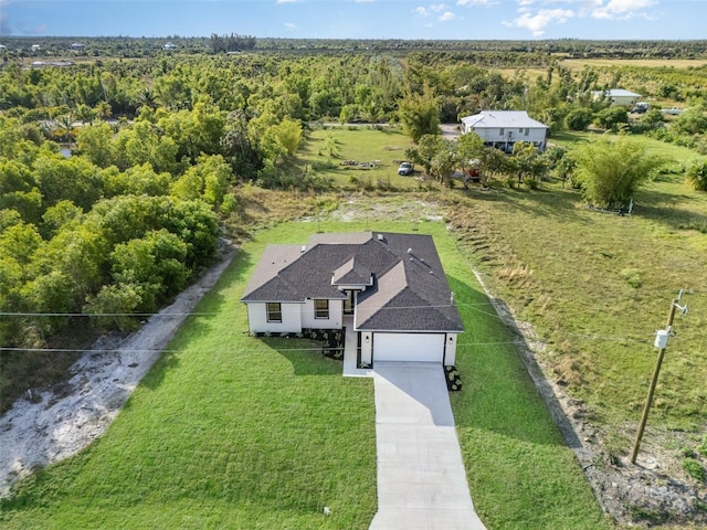 drone / aerial view featuring a forest view