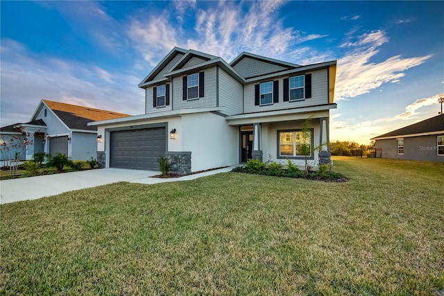 view of front of home featuring a front lawn and a garage