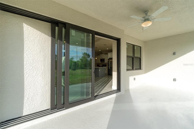 exterior space with ceiling fan