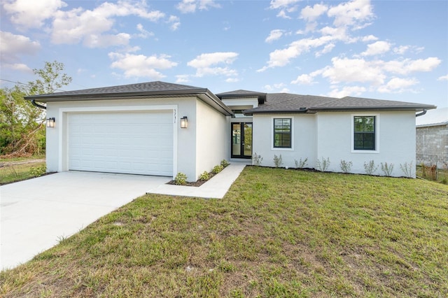 prairie-style home with a garage and a front lawn