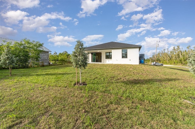 back of property featuring a lawn