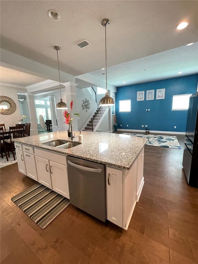 kitchen featuring sink, white cabinetry, light stone countertops, decorative light fixtures, and stainless steel dishwasher