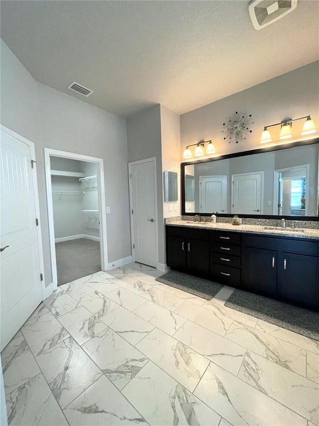 bathroom with vanity and a textured ceiling