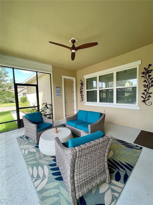 view of patio with ceiling fan and an outdoor living space