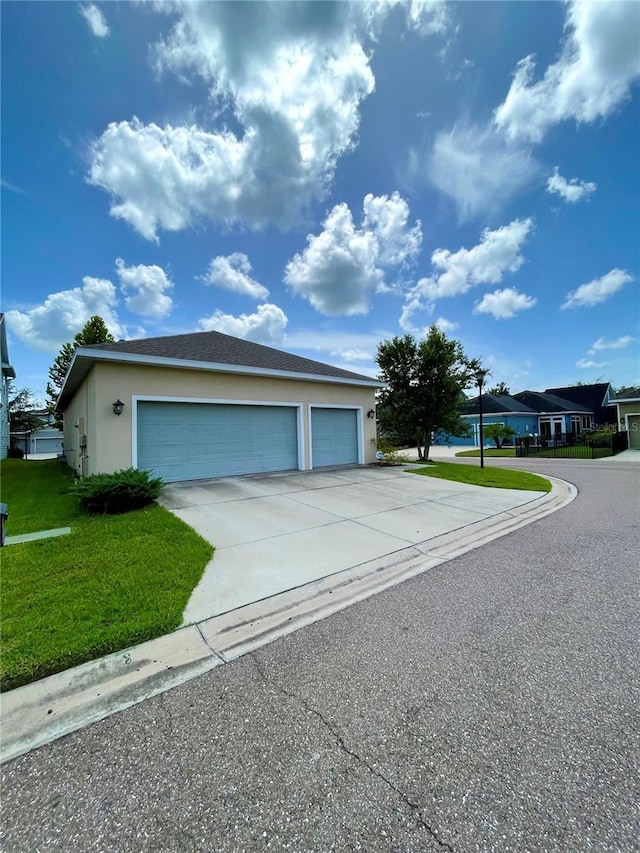 view of front of property with a garage and a front lawn