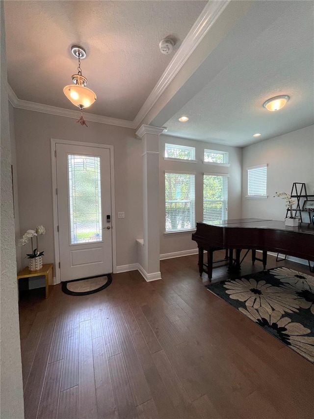 entryway featuring ornamental molding, dark hardwood / wood-style floors, and ornate columns