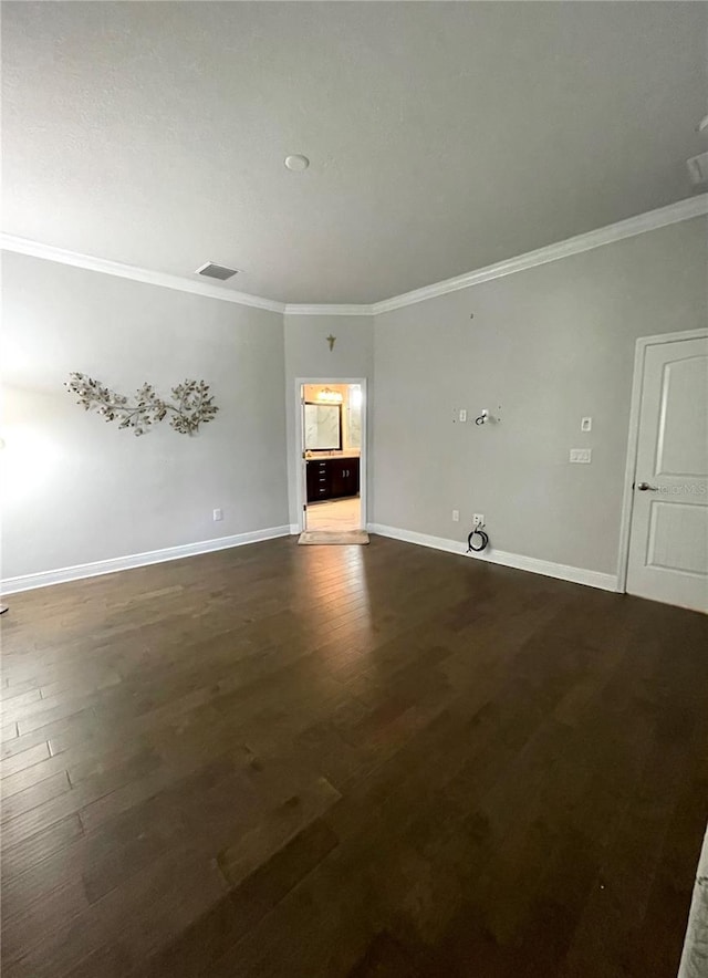 unfurnished living room featuring crown molding and dark hardwood / wood-style flooring