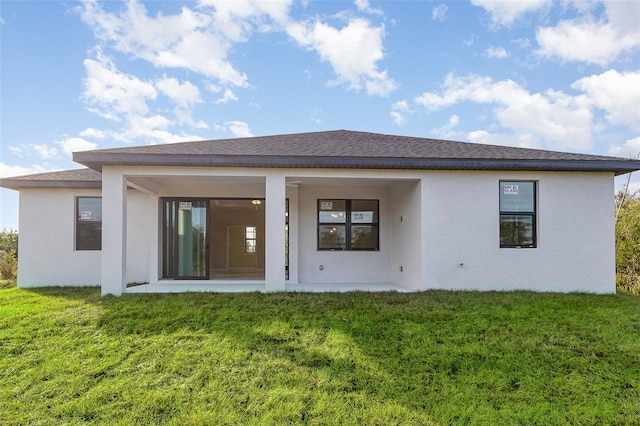 rear view of property with a yard