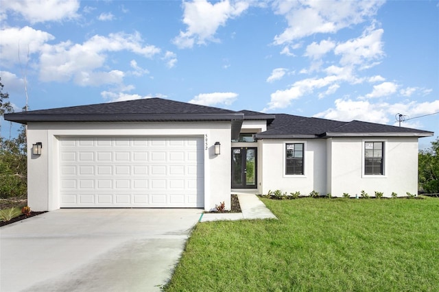 view of front facade with a garage and a front lawn