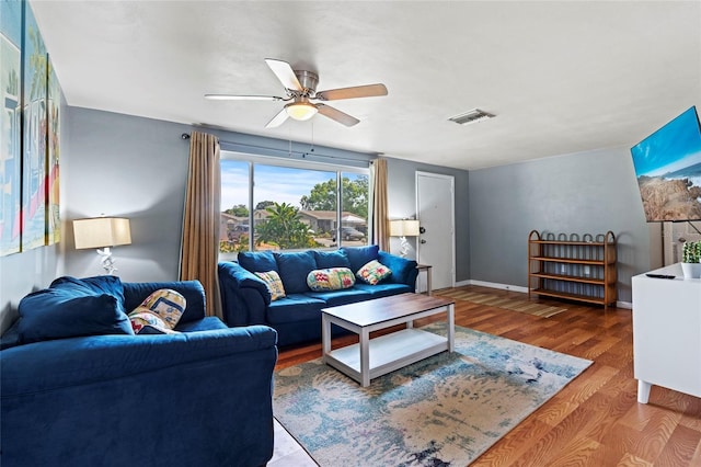 living room with ceiling fan and hardwood / wood-style flooring