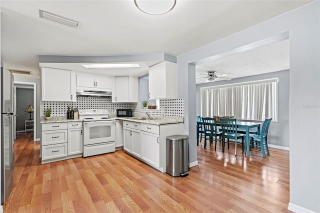 kitchen with light hardwood / wood-style floors, electric stove, and white cabinetry