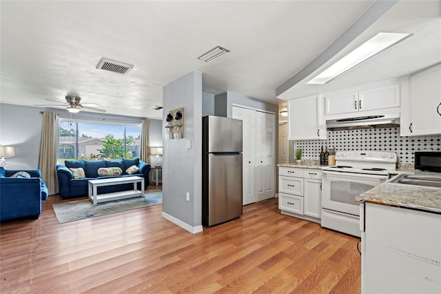 kitchen featuring white electric range, light hardwood / wood-style floors, white cabinetry, and stainless steel refrigerator