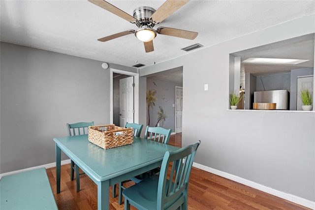 dining room with ceiling fan and wood-type flooring