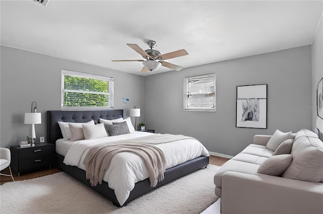 bedroom with ceiling fan and wood-type flooring