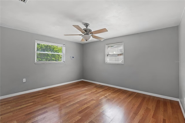 spare room with ceiling fan and wood-type flooring