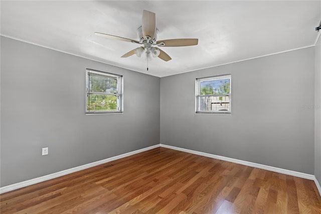 spare room with ceiling fan and hardwood / wood-style floors