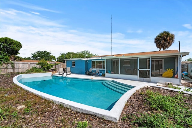 view of pool with a sunroom