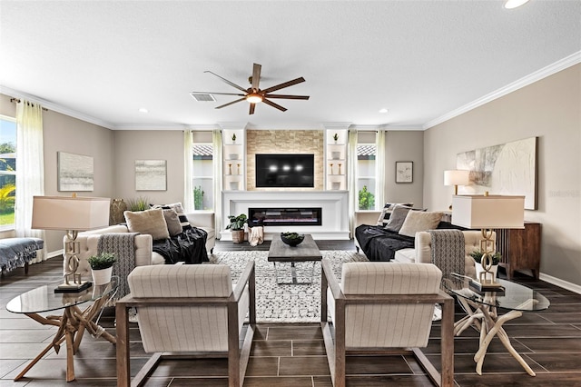 living room featuring ceiling fan, built in features, ornamental molding, and a fireplace