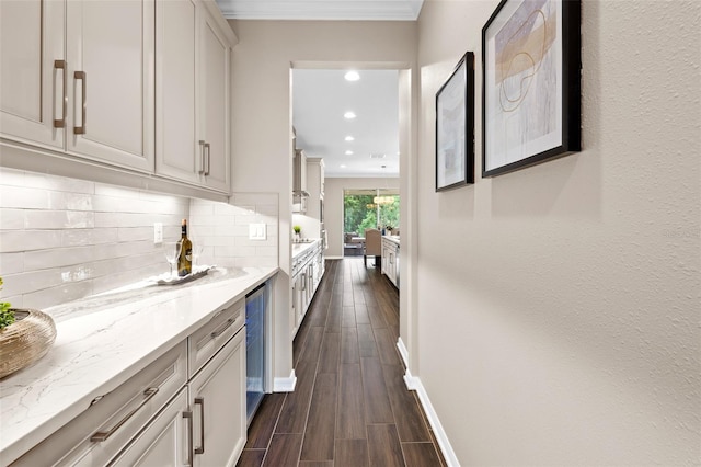 interior space with crown molding and beverage cooler