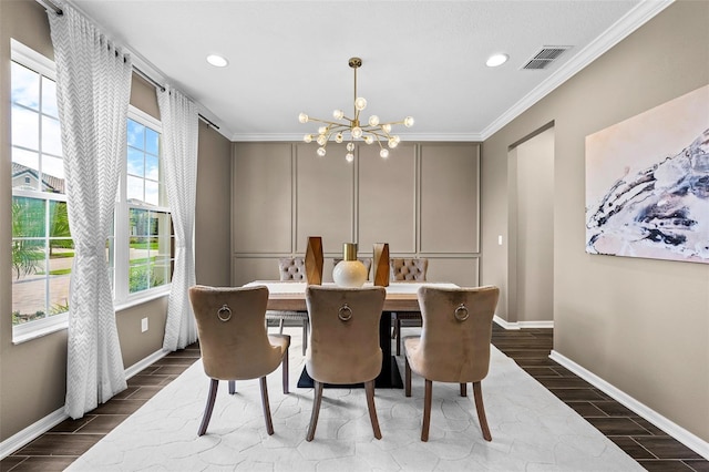 dining space featuring ornamental molding and a notable chandelier