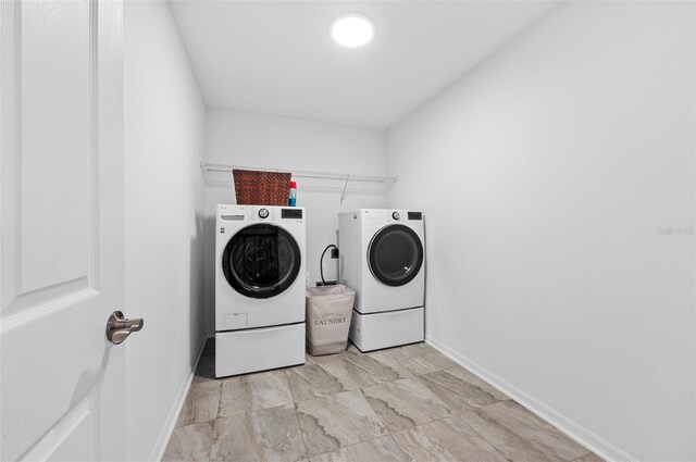 laundry room with washer and dryer