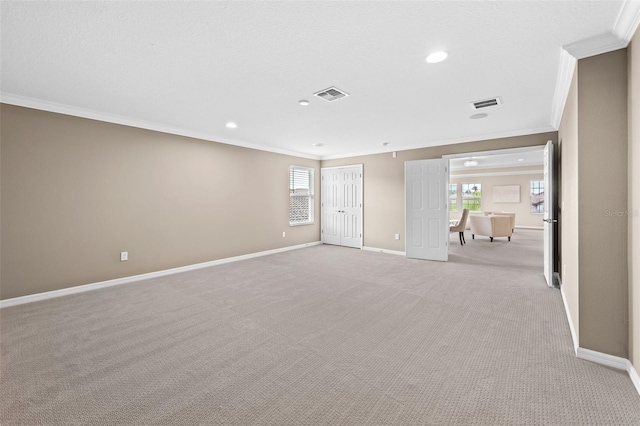 carpeted spare room featuring ornamental molding