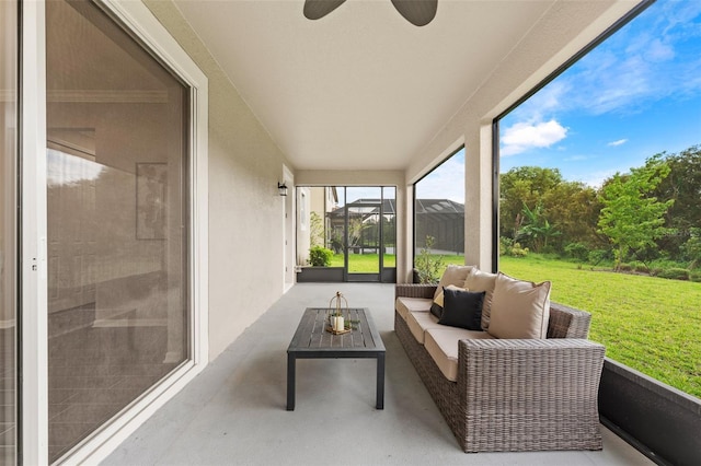 sunroom / solarium featuring ceiling fan