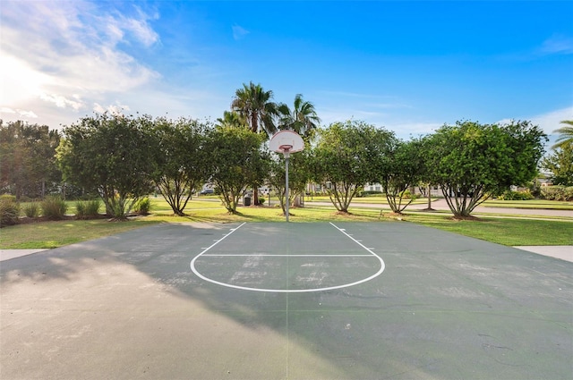 view of sport court with a lawn