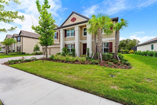 view of front of home with a garage and a front lawn