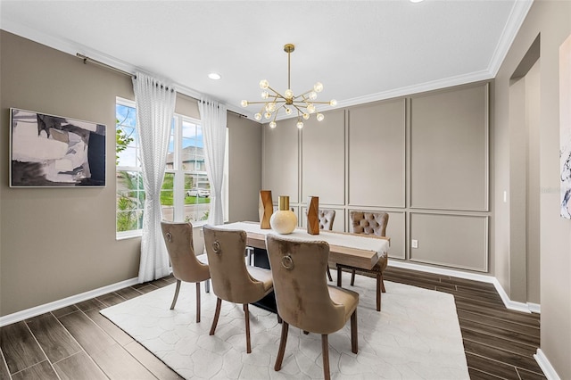 dining space with a decorative wall, wood tiled floor, a chandelier, and ornamental molding