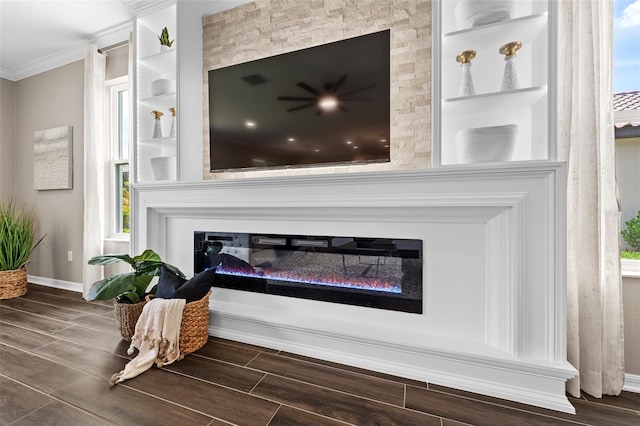 room details featuring wood finish floors, ornamental molding, and a glass covered fireplace